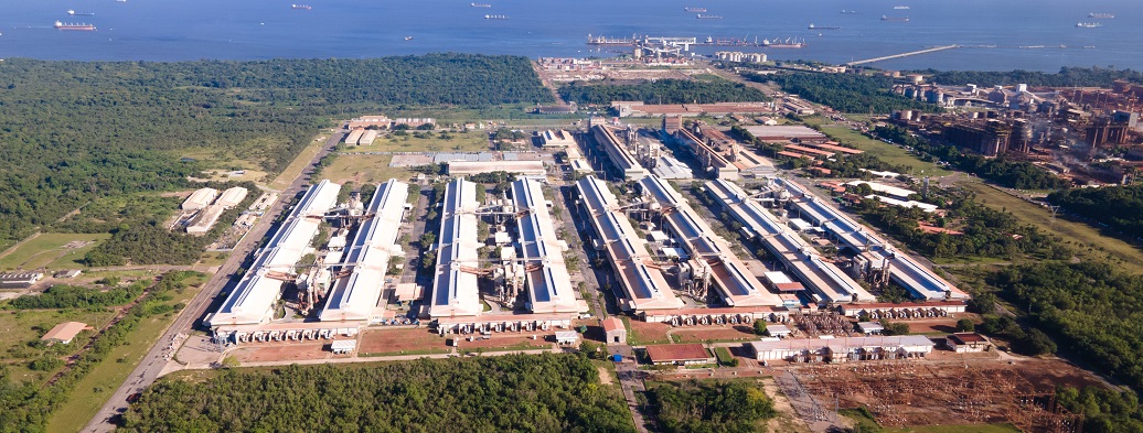a large building with a lot of windows and a road in the front