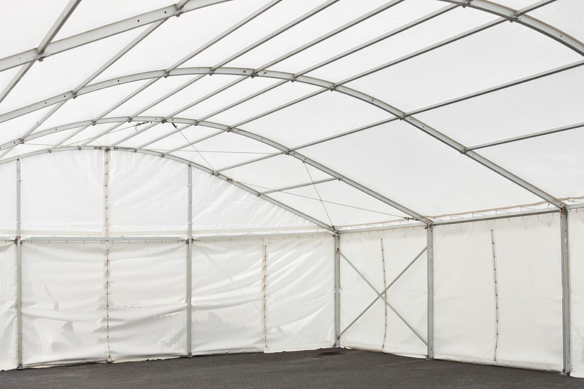 A white walled marquee interior with an aluminium frame
