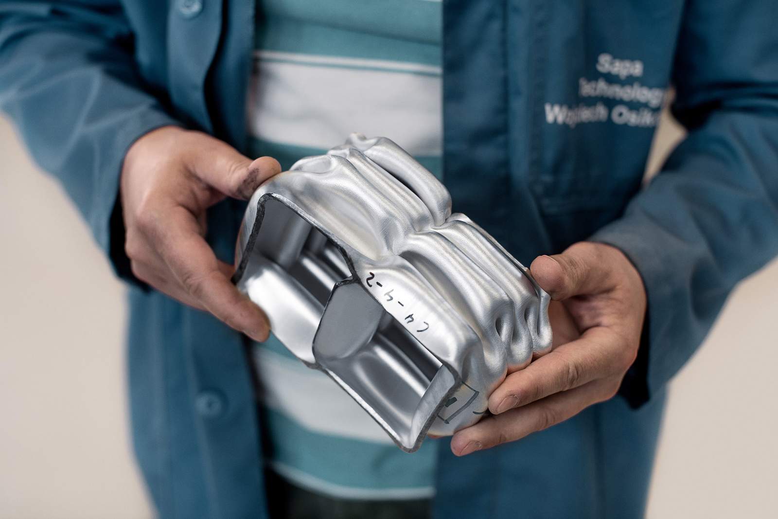 hands holding an extruded object