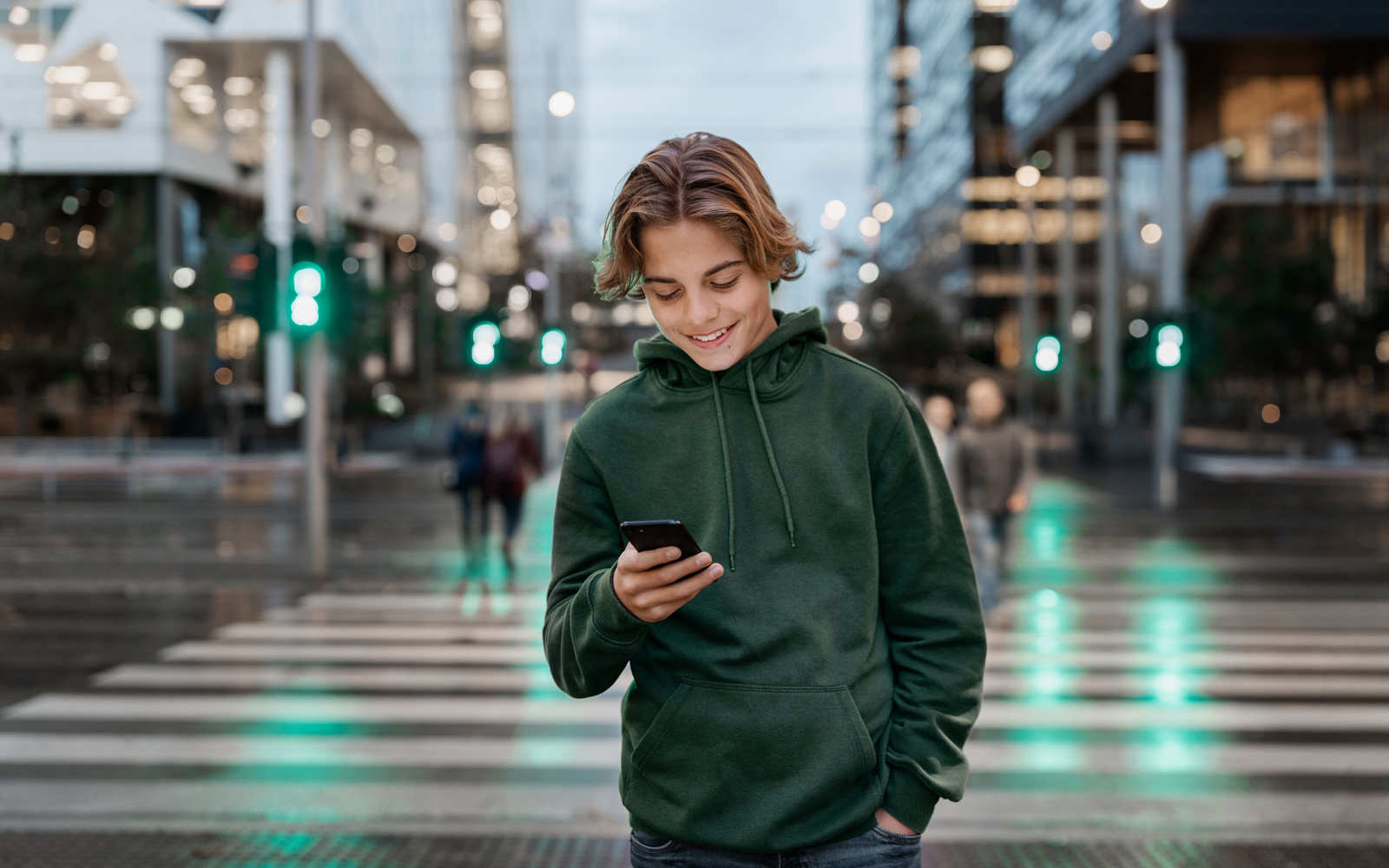 Young adult looking at his phone in urban environment