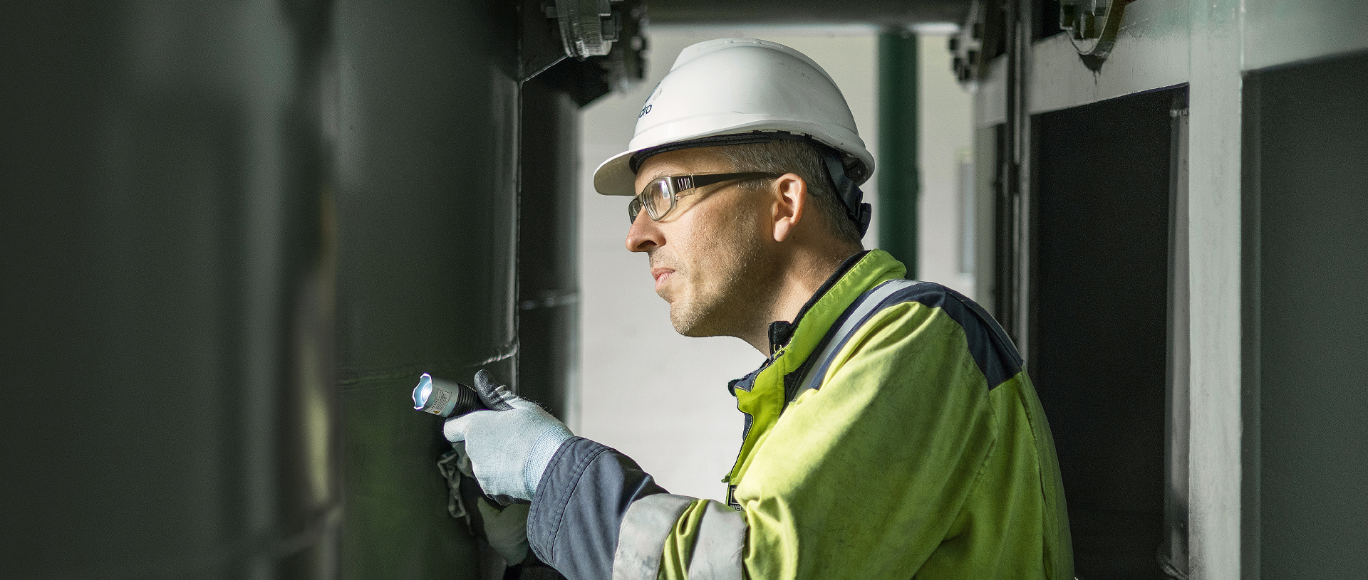 a man wearing a hard hat and safety goggles