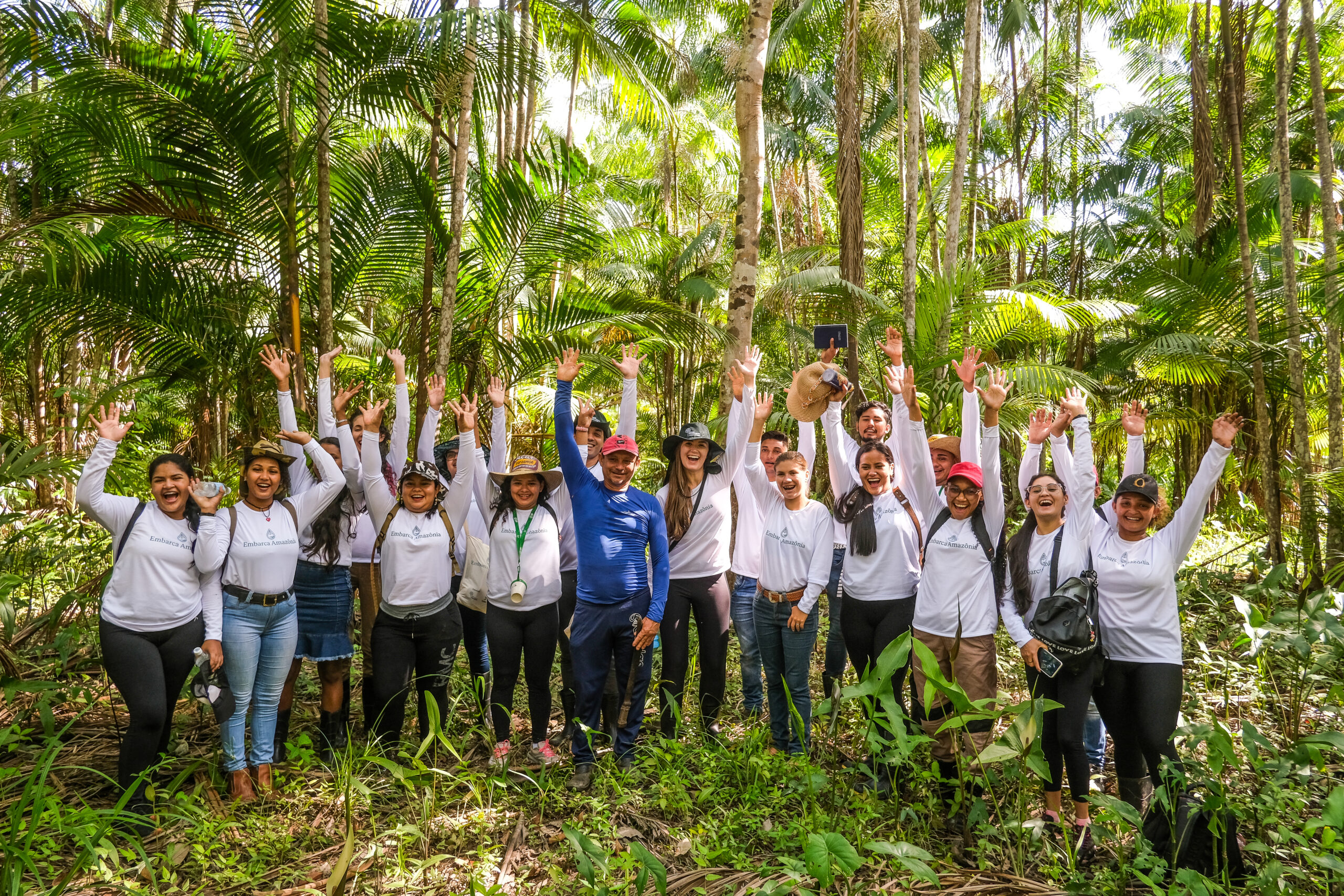a group of people posing for a photo in the woods