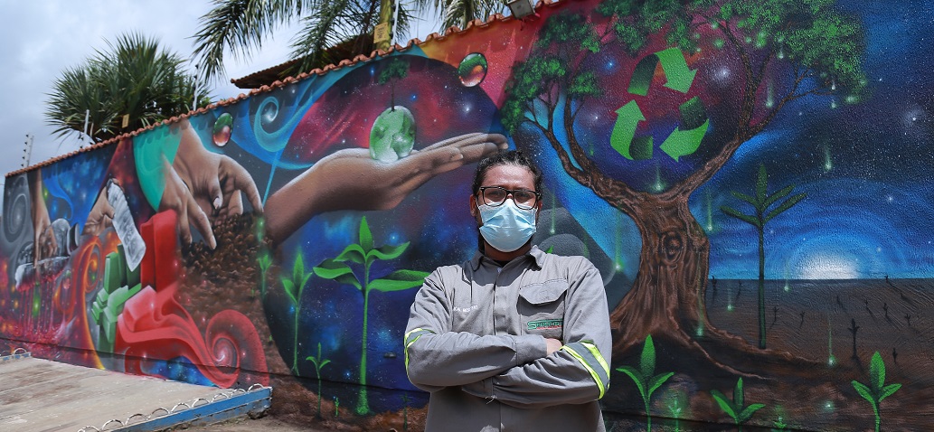 a person posing in front of a mural