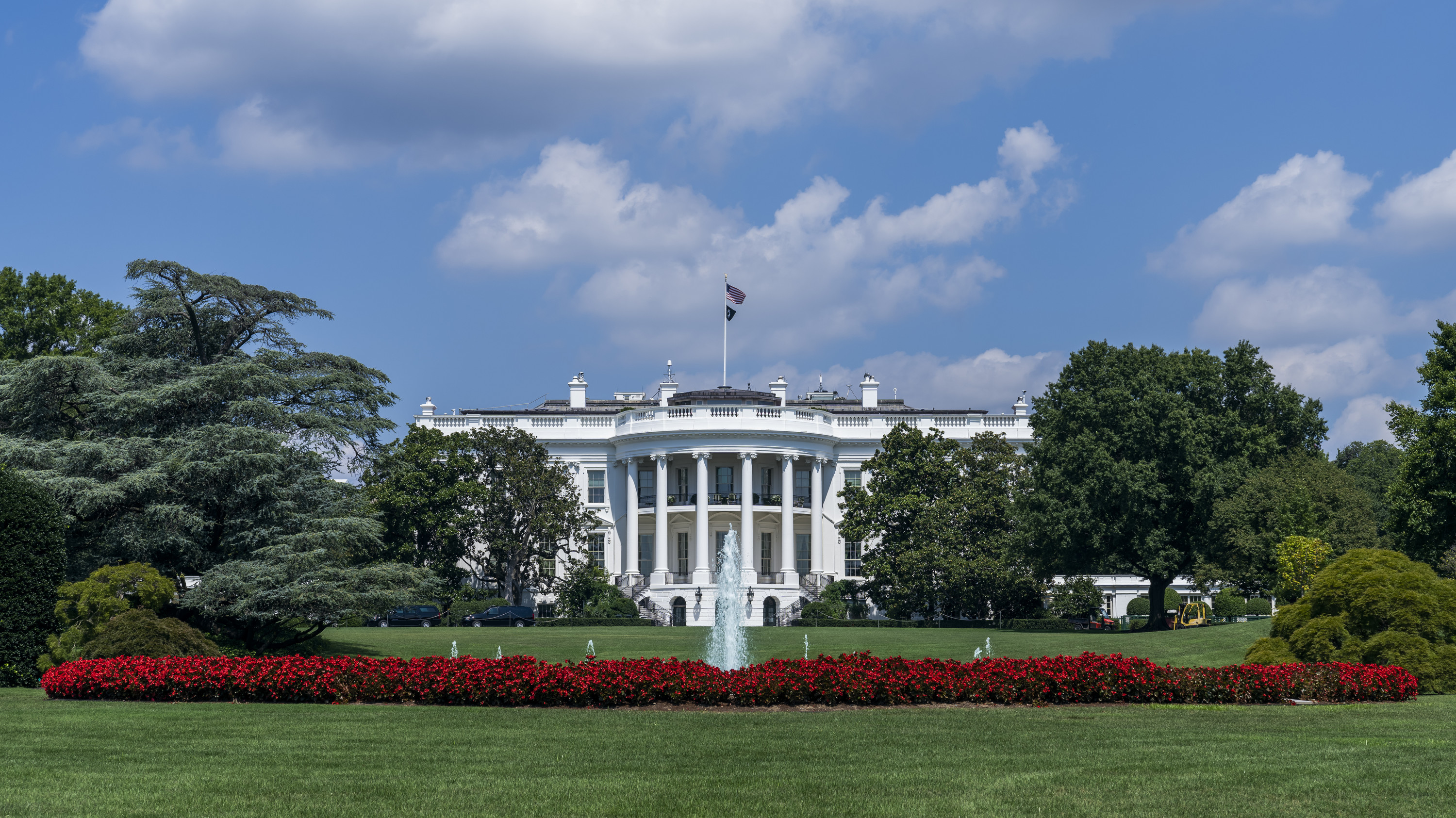a white house with a flag on top with White House in the background