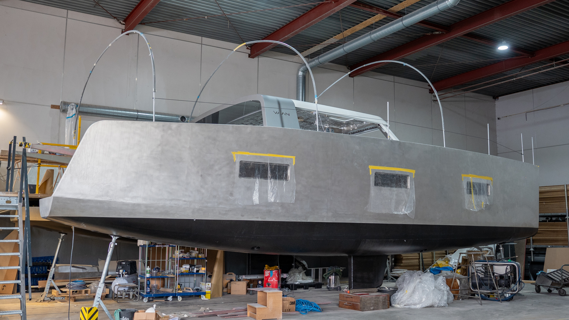 a grey boat hull in a factory 