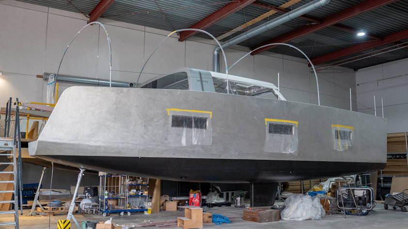 a grey boat hull in a factory