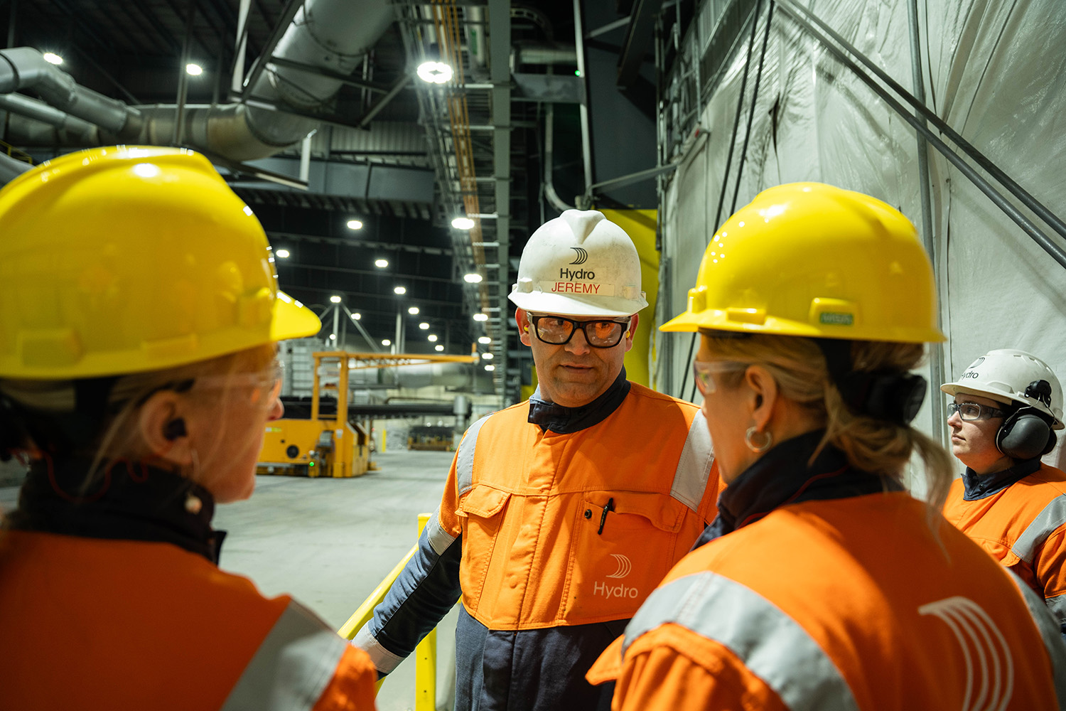 a group of people wearing hardhats and reflective clothing