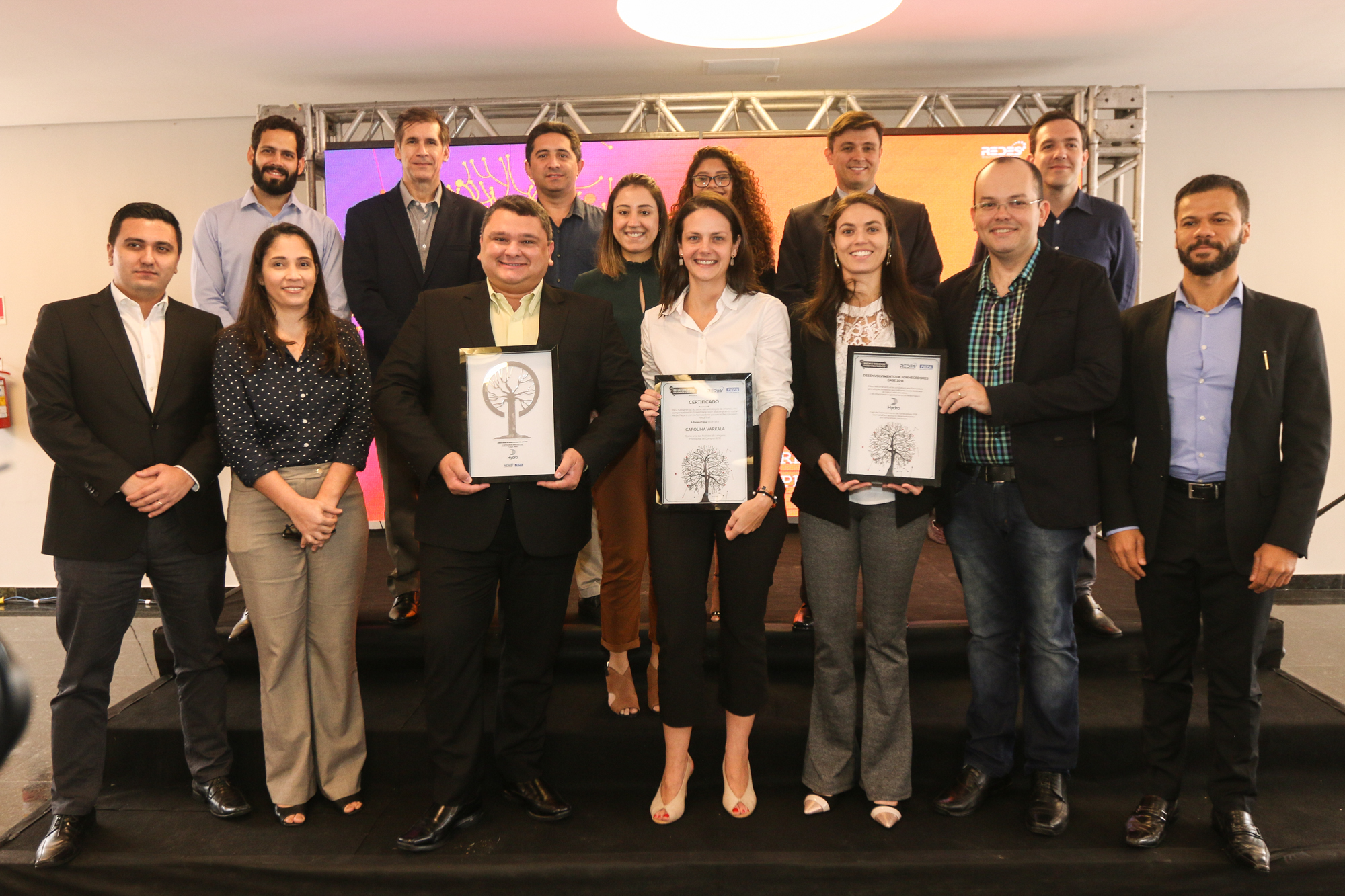 a group of people holding certificates
