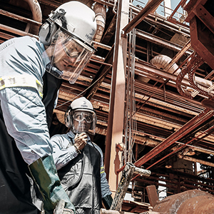men in hardhats working on a structure