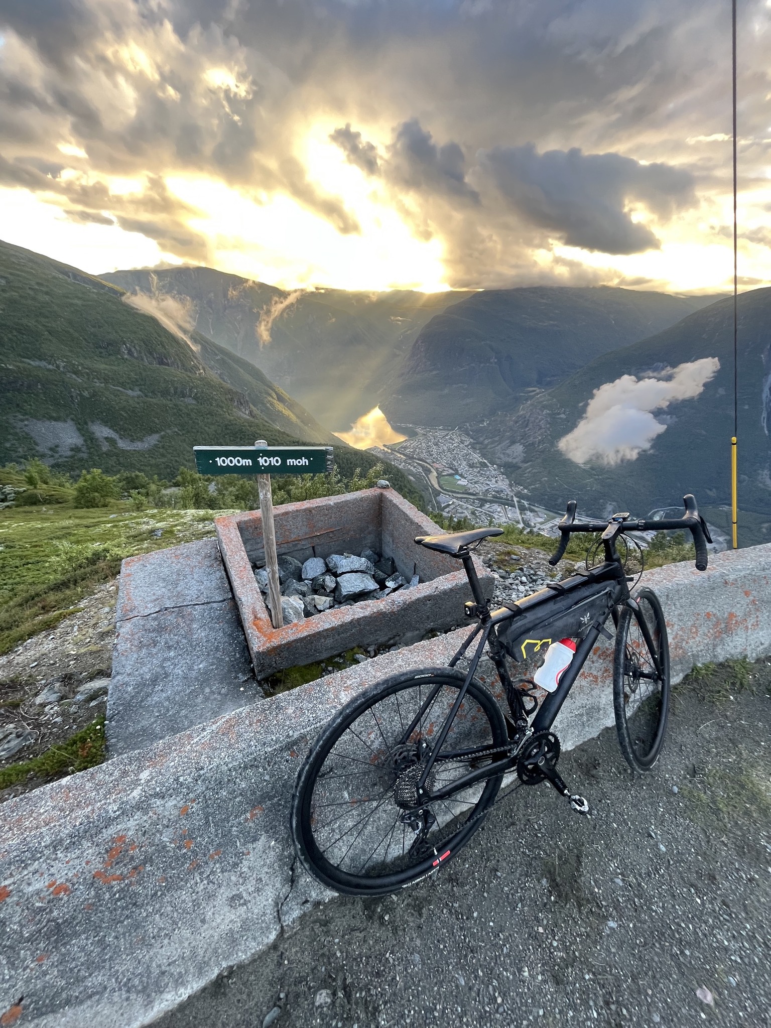 a bicycle parked next to a sign